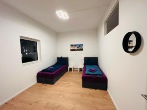 a living room with two beds and a window at Big Apartment l 18 Beds l Free Parking l WiFi l in Erwitte