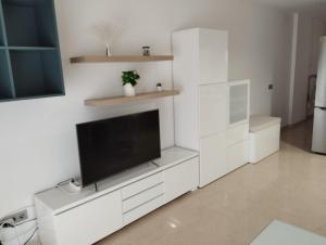 a white living room with a flat screen tv at VV ALSU La Palma in Breña Baja