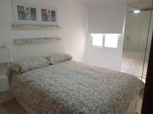 a bedroom with a bed in a white room at VV ALSU La Palma in Breña Baja