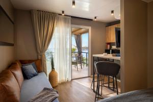 a living room with a couch and a kitchen with a balcony at Punto Blu Village in Lanterna Premium Camping Resort in Poreč