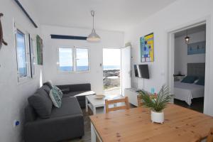 a living room with a couch and a table at Fischer Home Roque del Este in Punta Mujeres