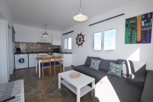 a living room with a couch and a table at Fischer Home Roque del Este in Punta Mujeres