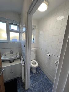 a bathroom with a toilet and a sink at Spacious One Bedroom Private Flat in Brixton +Wifi in London