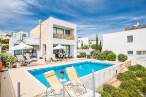 a villa with a swimming pool and a house at Villa Latchi View in Neo Chorio