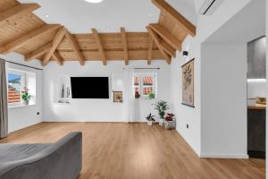 a living room with white walls and a flat screen tv at Apartment Vise - Old Town Center, Stone Terrace in Omiš