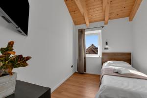 a bedroom with a bed with two towels on it at Apartment Vise - Old Town Center, Stone Terrace in Omiš