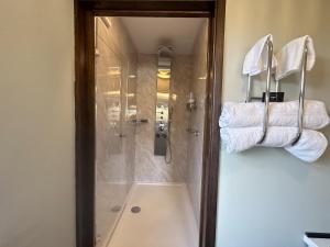 a bathroom with a shower with towels on the wall at Heathwood in Dover