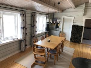 a dining room with a wooden table and chairs at Stuga , Funäsdalen in Funäsdalen