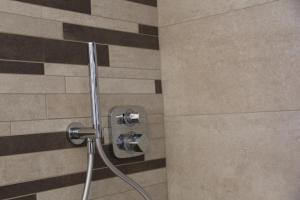a shower with a hose in a bathroom at The Blue Nest - Red Apartment near 5 Terre in La Spezia +22 photos