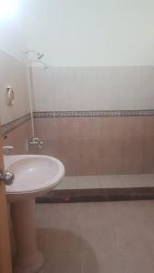 a bathroom with a sink and a shower at Residency Girls Hostel - For Females Only in Lahore