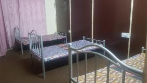 two bunk beds in a room with pink curtains at Residency Girls Hostel - For Females Only in Lahore