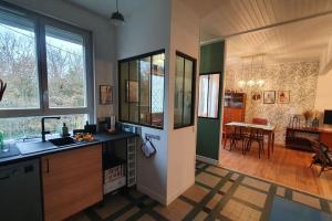 a kitchen with a sink and a counter top at L'Orée Du Bois in Huelgoat