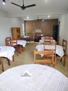 a room with tables and chairs and a living room at Hotel Village Cataguases in Cataguases