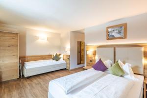 sypialnia z 2 łóżkami w pokoju w obiekcie Albergo Belvedere w mieście Vigo di Fassa +26 zdjęć