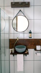 a bathroom with a sink and a mirror at Pousada Monttana in Lavras Novas