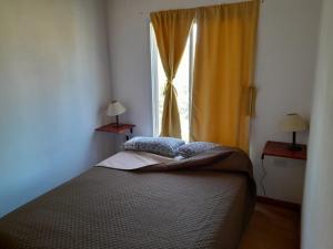 a bedroom with a bed in front of a window at Sol de Belen in San José