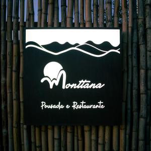 a sign on the side of a bamboo wall with waves at Pousada Monttana in Lavras Novas