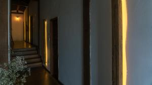 a hallway of a building with stairs and a doorway at Pousada Monttana in Lavras Novas