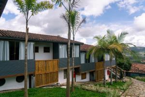 a resort with palm trees in front of it at Pousada Monttana in Lavras Novas