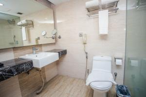 a bathroom with a white toilet and a sink at Days Hotel Dhaka in Dhaka +34 photos