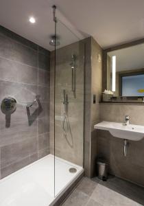 a bathroom with a shower and a sink at The Samuel Hotel in Dublin
