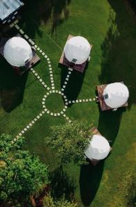 an aerial view of a park with white domes at Yubarta Lodge in Uvita