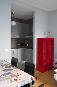 a kitchen with a refrigerator, sink, and dishwasher at Apartamentos San Pablo in Málaga