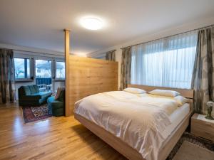 a bedroom with a large bed with a wooden headboard at Ferienwohnung Wallner in Zell am Ziller