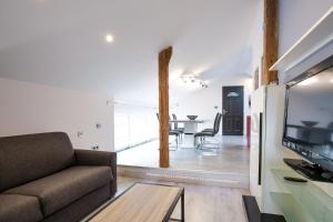 a living room with a couch and a table at L’olivier in Montmerle Sur Saône