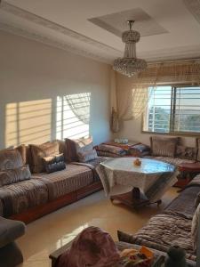 - un salon avec des canapés et une table dans l'établissement Appartement wifaq, à Temara