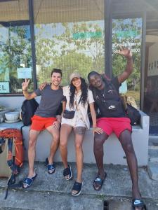 a group of three people sitting on a bench at Backpack Hostel Kohyaoyai in Ko Yao Yai