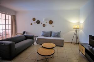 a living room with a couch and a table at Aquamar Albufeira Aparthotel in Albufeira