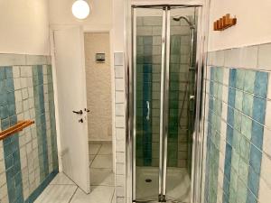 a shower with a glass door in a bathroom at Villa Angela in Santa Teresa Gallura