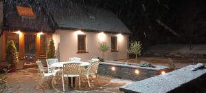 a patio with a table and chairs in front of a house at Boatman's Quarters in Skibbereen