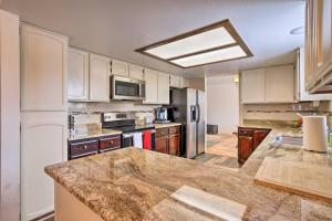 a kitchen with white cabinets and a large counter top at Family-Friendly Aurora Vacation Rental with Yard! in Aurora