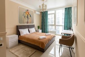 a bedroom with a bed with green curtains and a window at Sun apartments in Kyiv