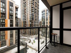 a balcony with a view of a city with tall buildings at Sun apartments in Kyiv