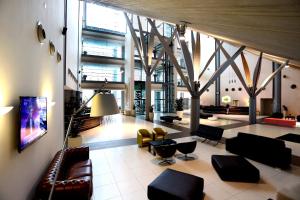 a lobby with couches and chairs in a building at Holiday Inn Nola - Naples Vulcano Buono, an IHG Hotel in Nola