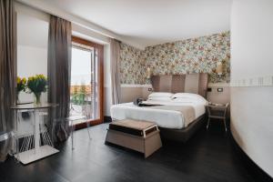 a hotel room with a bed and a window at Unica Suites Rome in Rome