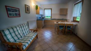 a living room with a couch and a table at Casa al Portico in Ledro