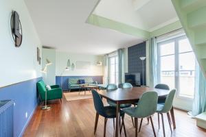 a dining room with a table and chairs at Duplex Chancelier - Fairytale Factory in Bussy-Saint-Georges