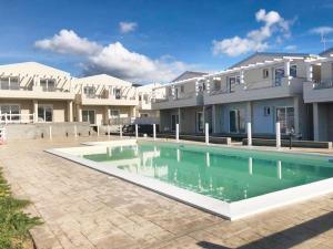 a swimming pool in front of a building at Affittimoderni Viddalba Bouganville - VIBO11 in Viddalba +14 photos