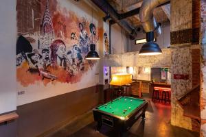 a pub with a pool table in a room at MEININGER Hotels Bruxelles City Center in Brussels