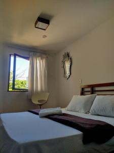 a bedroom with a large bed and a window at Luna Rossa Guest House in Rio de Janeiro