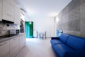 a living room with a blue couch in a kitchen at Blue Loft - The House Of Travelers in Como +34 photos