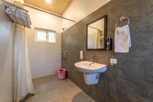 a bathroom with a sink and a mirror at Zostel Plus Nainital (Naina Range) in Nainital