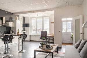 a living room with a couch and a table at Le Hublot - Meublé Tourisme Classé 3 étoiles in Cherbourg en Cotentin