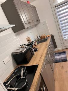 a kitchen with a sink and a stove in it at * NEW STYLE proche de la gare * in Le Mans