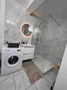 a white bathroom with a washing machine and a sink at * NEW STYLE proche de la gare * in Le Mans