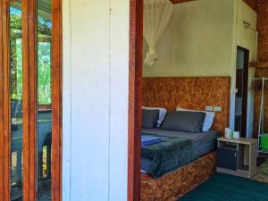a bedroom with a bed in the corner of a room at Nakhokyor Farm in Ko Yao Yai